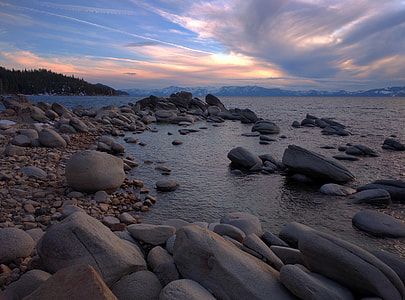 grey stones on seashore during golden hour time thumbnail