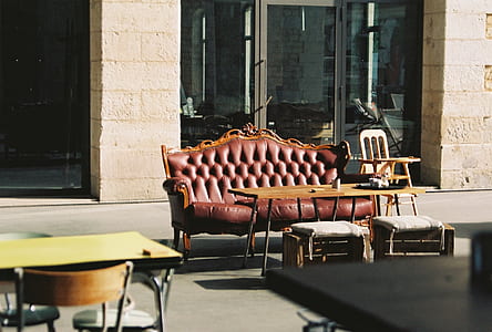 brown leather sofa outside beige building thumbnail