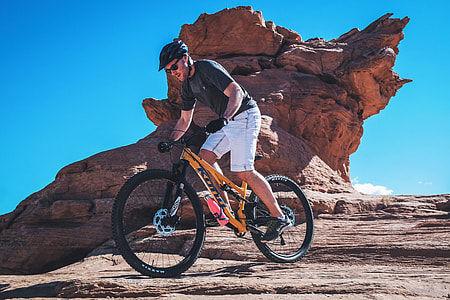 A man riding exercises on a mountain bicycle on rocky terrain thumbnail