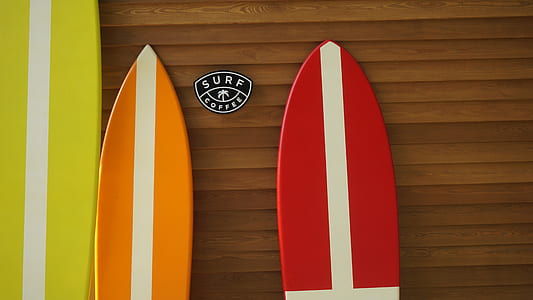 three assorted-color surfboards thumbnail