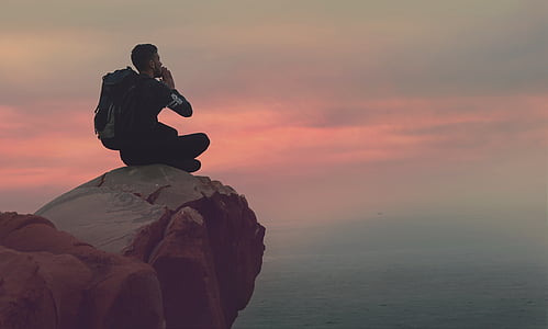 man sitting on cliff thumbnail
