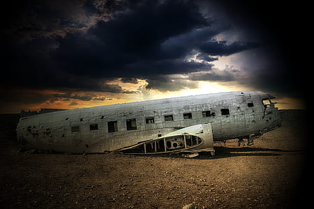 photo of wrecked airplane on brown sand thumbnail