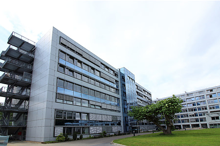 white and gray curtain building under white clouds thumbnail