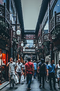 photo of people passing by an alley thumbnail