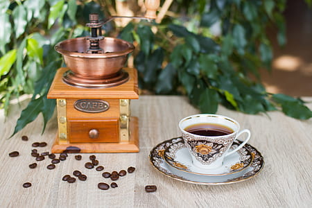 brown coffee grinder beside cup thumbnail