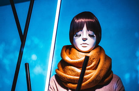 Woman Closing Eyes Wearing Brown Scarf thumbnail