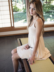 woman wearing white spaghetti strap dress thumbnail