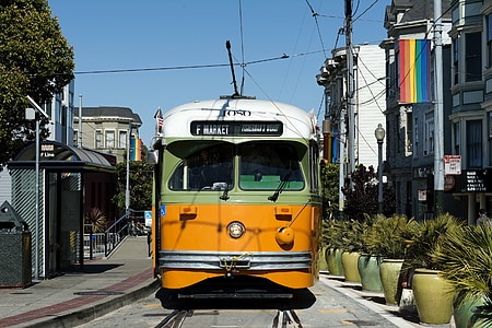 orange, green, and white train during daytime thumbnail