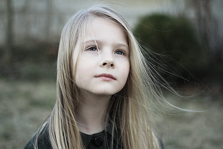girl wearing black top looking above thumbnail
