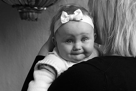 grayscale photography of woman carrying baby thumbnail