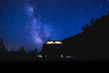 silhouette of vehicle under starry night thumbnail