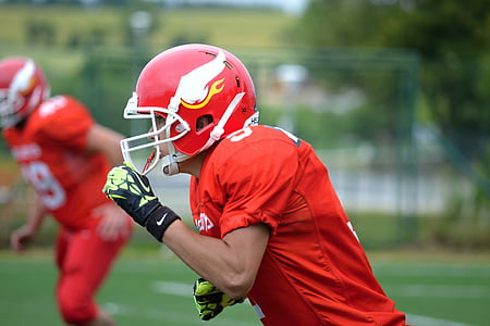 man in red football shirt and helmet thumbnail