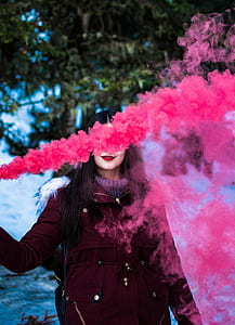 pink smoke covering woman's face thumbnail
