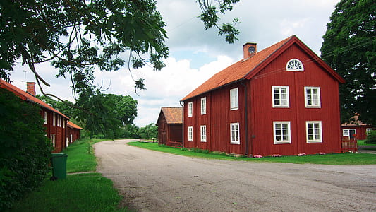 brown wooden house near tree at daytime thumbnail