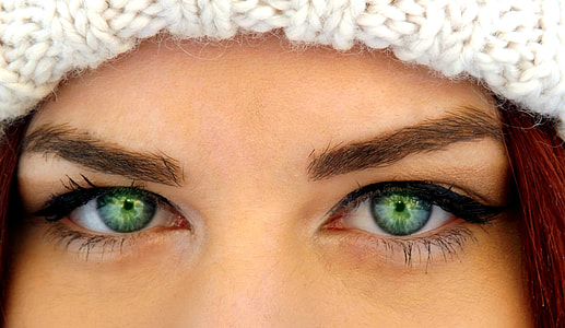 woman with green eyes wearing white crochet hat thumbnail