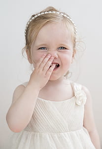 girl wearing white dress standing near wall thumbnail