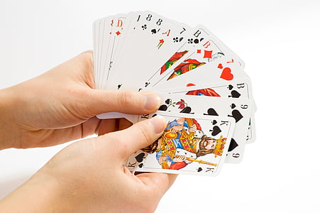 person holding playing cards thumbnail