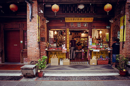 person standing near open store with hanged lanterns thumbnail