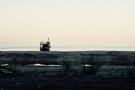 white and black pontoon boat on ocean under cloudy sky at daytime thumbnail