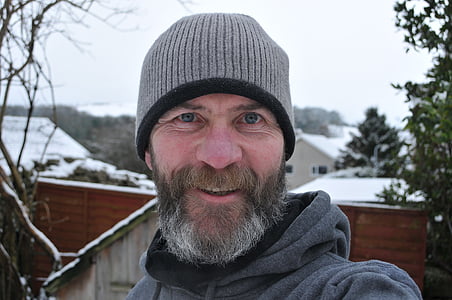 smiling man wearing gray knit hat outdoor thumbnail