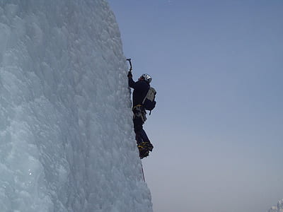 man climbing a snow covered mountain thumbnail