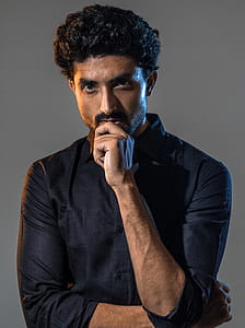 Photo of Man Holding His Chin thumbnail