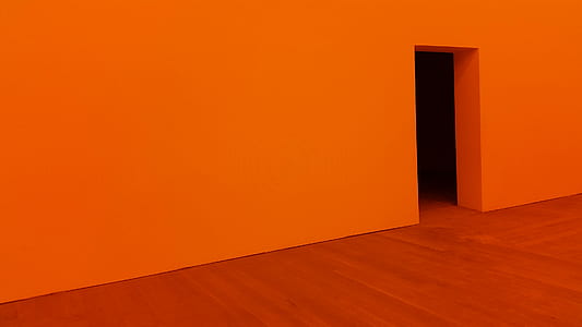 red wall with opened doorway on red floor thumbnail