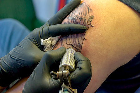 person drawing tattoo thumbnail