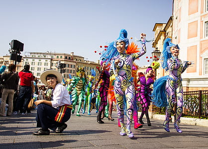 women dancing beside boy on pavement thumbnail
