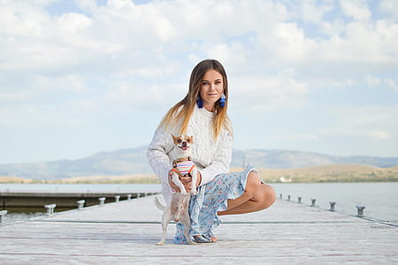 woman holding chihuahua on dock thumbnail