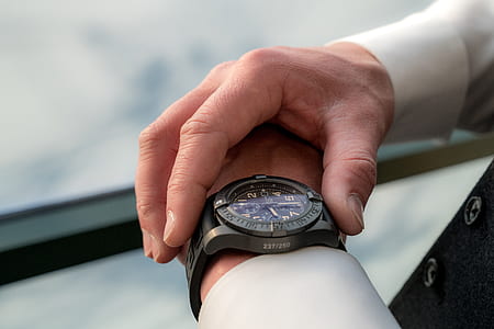 person adjusting his wristwatch thumbnail