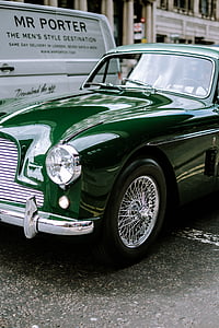 green car parked on gray concrete pavement thumbnail