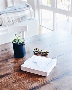 flay lay photography of book beside eyeglasses and jar thumbnail