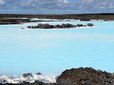 rippling body of water surrounded with rocks thumbnail