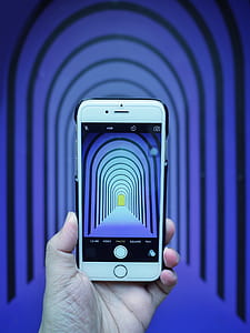 person holding silver iPhone 6 and black case thumbnail