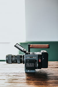 black and gray camcorder on brown wooden table thumbnail