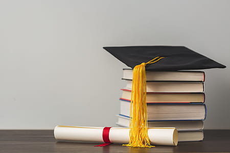 Grad Cap Diploma And Stacked Books Photo thumbnail