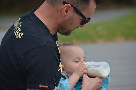 baby feeding milk by man thumbnail