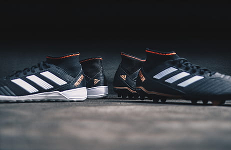 two pairs of black adidas cleats thumbnail