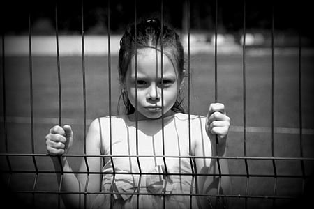 girl standing beside fence thumbnail