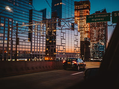 black car on road near buildings thumbnail