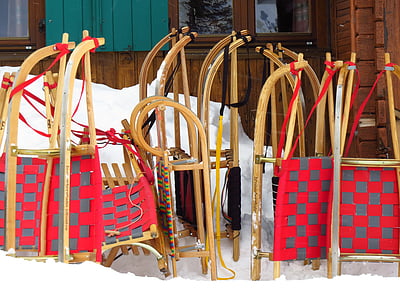 brown wooden snow sleds near door thumbnail