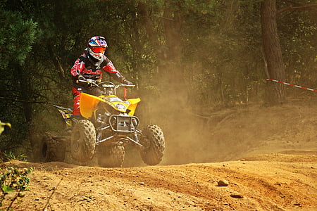 man riding ATV on dirt road thumbnail