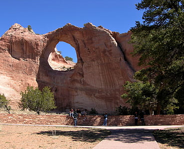 group of people near rock formation thumbnail