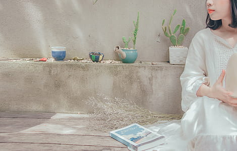 Photography of a Woman Sitting Near Ledge thumbnail