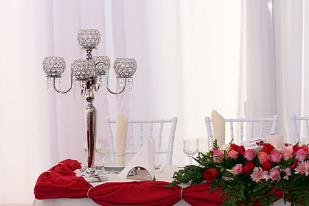 pink and red roses flower arrangement beside candle holder thumbnail