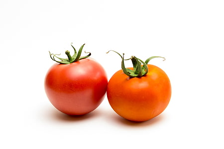 two red and orange tomatoes on white surface thumbnail
