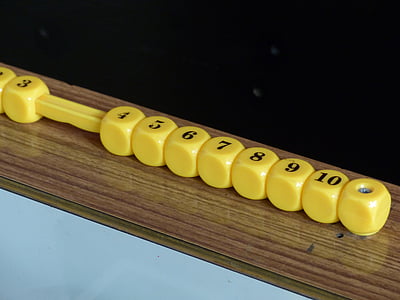 yellow dice on brown surface thumbnail