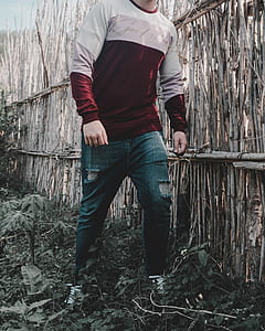 man walking beside brown wooden fence thumbnail
