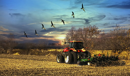 red and black tractor on field landscape photography thumbnail